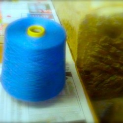 a large roll of 32 blue thread